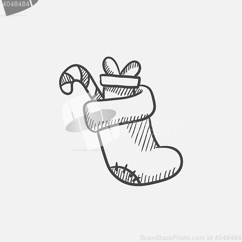 Image of Christmas boot with gift and candy cane sketch icon.