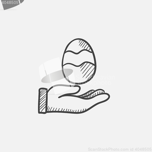 Image of Hand holding easter egg sketch icon.