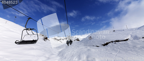 Image of Panoramic view on chair-lift at ski resort at sun winter day
