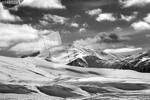 Image of Black and white ski slope and beautiful sky with clouds in sun e