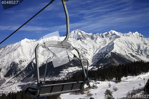 Image of Chair-lift at ski resort and snow winter mountains in nice sun d