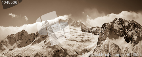 Image of Panorama of sunny winter mountains in clouds