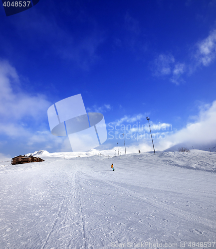 Image of Snowboarder on ski slope in nice sun day