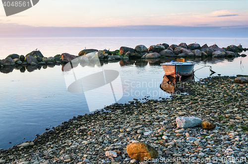 Image of Sunset and fishing boat on the coast