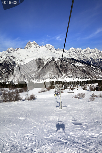 Image of Chair-lift and Mount Ushba in sun day