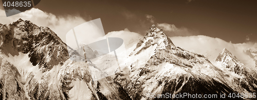 Image of Panorama of winter mountains in clouds