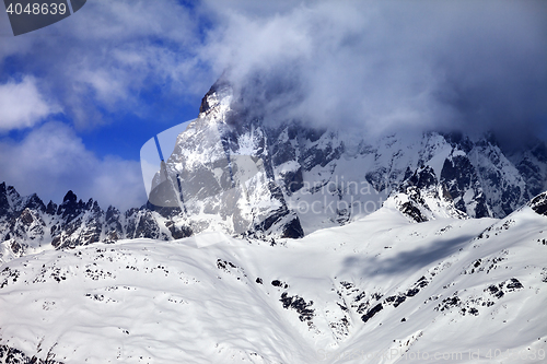 Image of Mount Ushba in fog at sun winter day before storm
