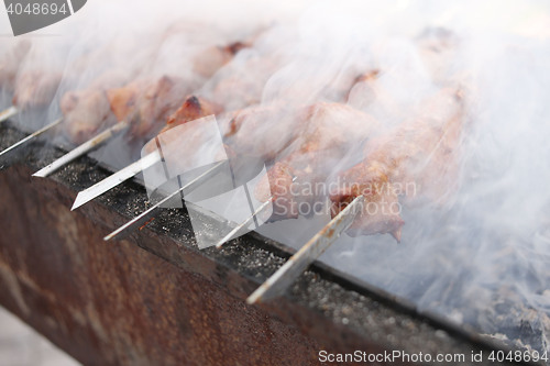 Image of Grilling marinated shashlik on a grill. Shish kebab popular in Eastern, Central Europe and other places. 