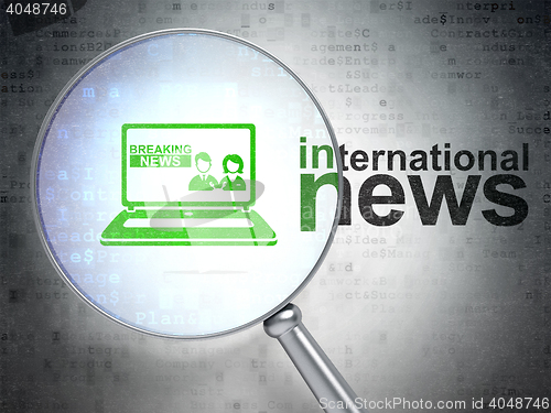 Image of News concept: Breaking News On Laptop and International News with optical glass