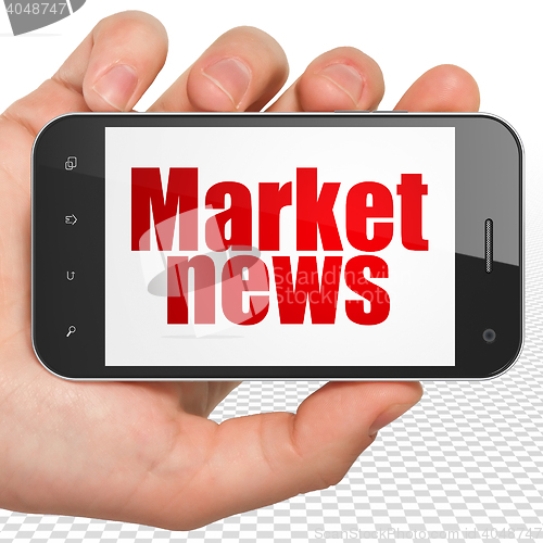 Image of News concept: Hand Holding Smartphone with Market News on display