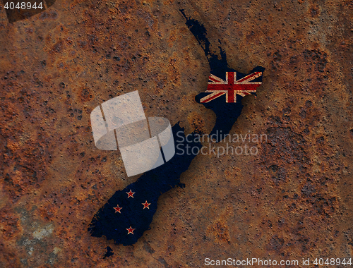 Image of Map and flag of New Zealand on rusty metal,