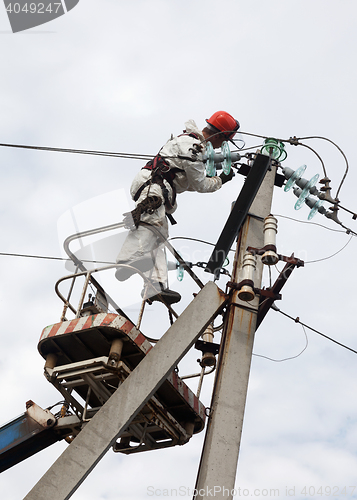 Image of Electrician working at a pillar