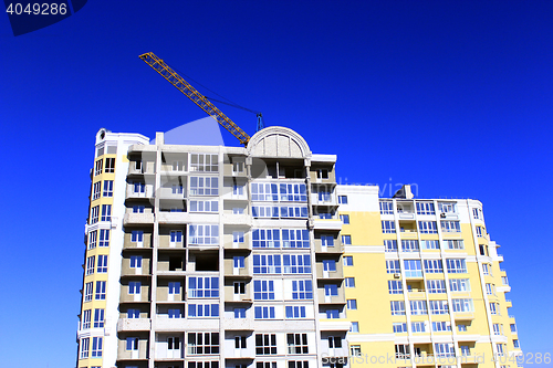 Image of modern skyscraper with hoisting crane