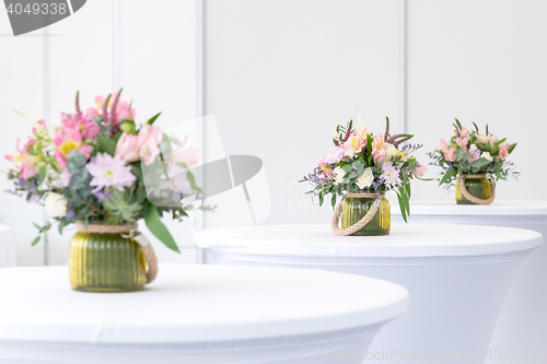 Image of beautiful flower arrangement on white festive tables