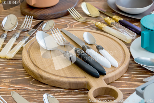 Image of Fork Spoon Table Knife on the wooden Cutting board