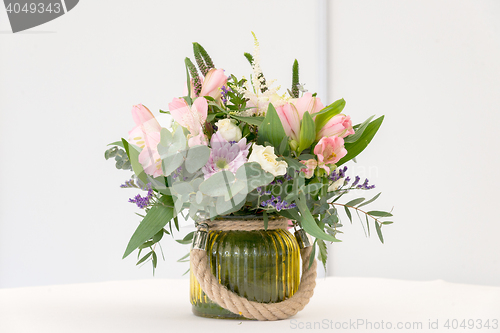 Image of beautiful flower arrangement on white festive table