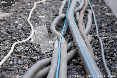 Image of trail of power electrical cables on the ground