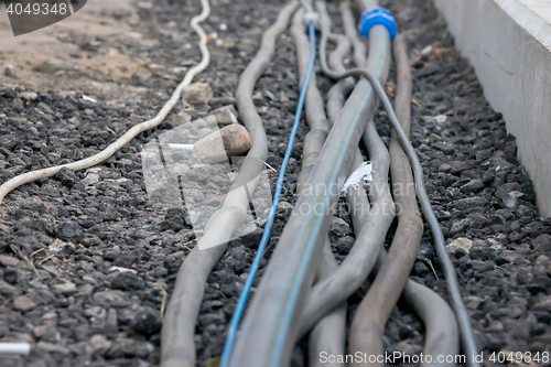 Image of trail of power electrical cables on the ground