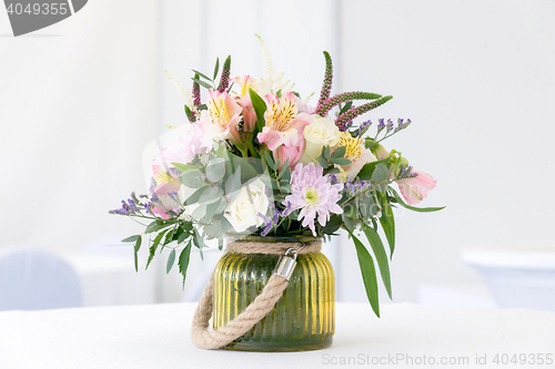 Image of beautiful flower arrangement on white festive table