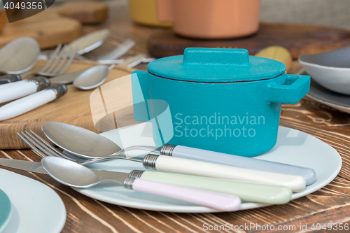 Image of new modern cast iron cauldron and kitchen appliances