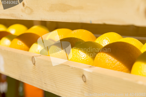 Image of fresh oranges in a wooden box