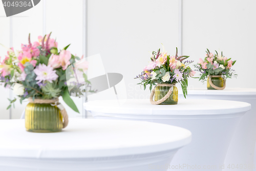 Image of beautiful flower arrangement on white festive tables