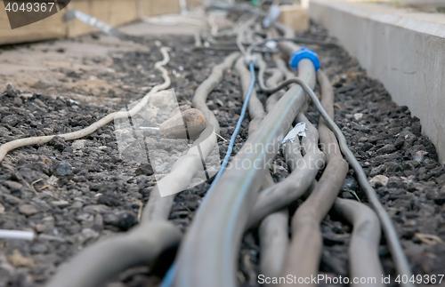 Image of trail of power electrical cables on the ground