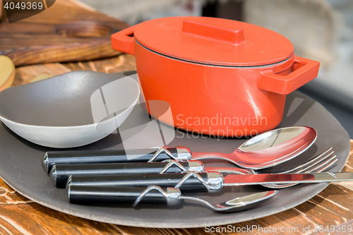 Image of new modern cast iron cauldron and kitchen appliances