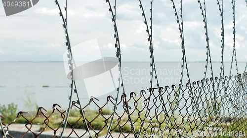 Image of Sea behind barbed wire 