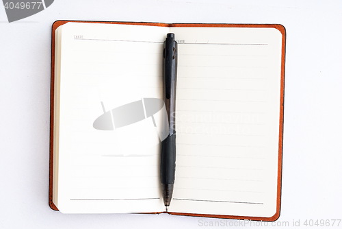 Image of notepad with pen isolated