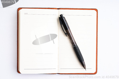 Image of notepad with pen isolated