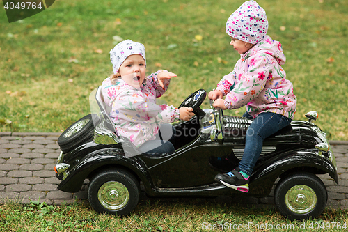 Image of The little baby girl playing at car