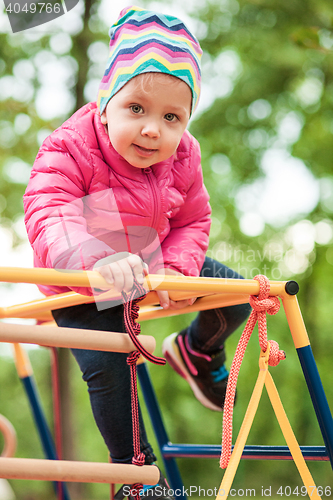 Image of The little baby girl playing at outdoor playground