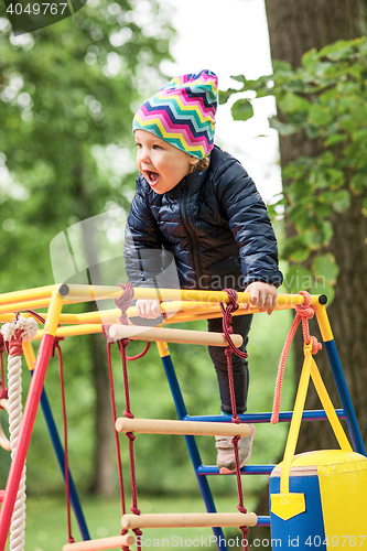 Image of The little baby girl playing at outdoor playground