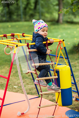 Image of The little baby girl playing at outdoor playground