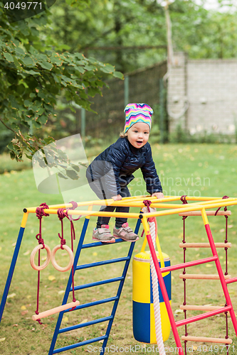 Image of The little baby girl playing at outdoor playground