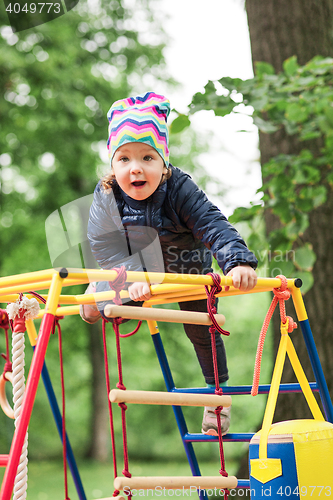 Image of The little baby girl playing at outdoor playground