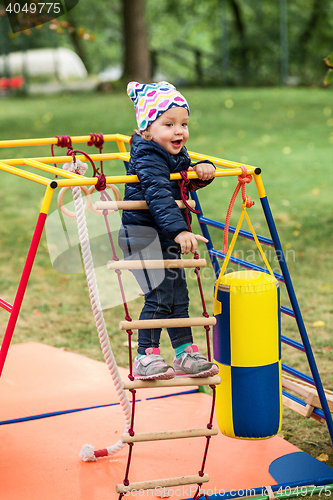 Image of The little baby girl playing at outdoor playground