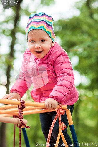 Image of The little baby girl playing at outdoor playground