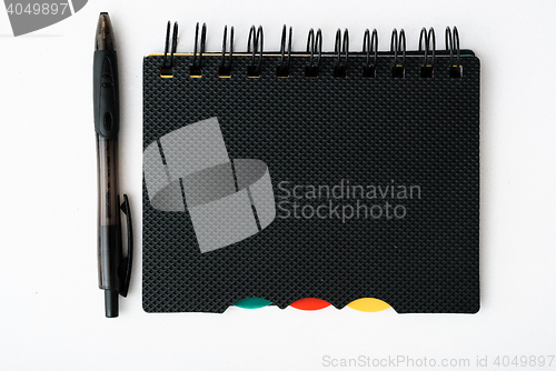 Image of notepad with pen isolated