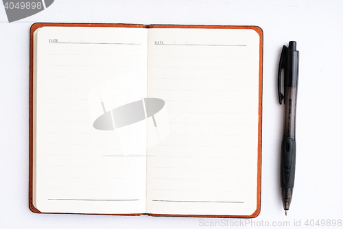 Image of notepad with pen isolated