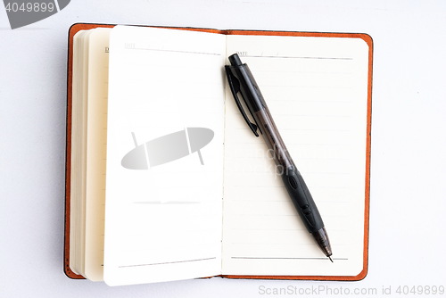 Image of notepad with pen isolated