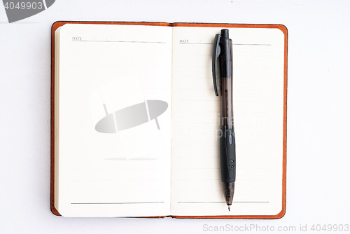 Image of notepad with pen isolated