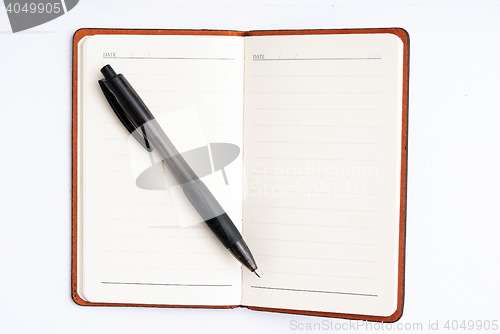 Image of notepad with pen isolated