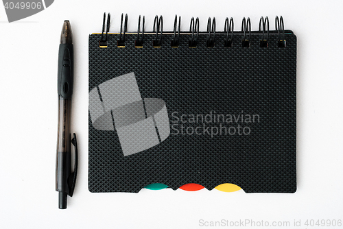 Image of notepad with pen isolated