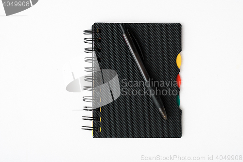 Image of notepad with pen isolated