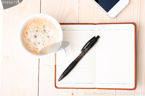 Image of Smartphone with notebook and cup of strong coffee