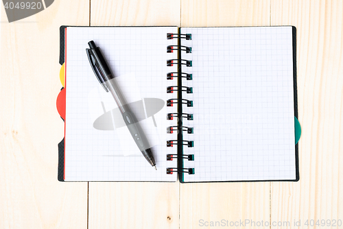 Image of notepad with pen isolated