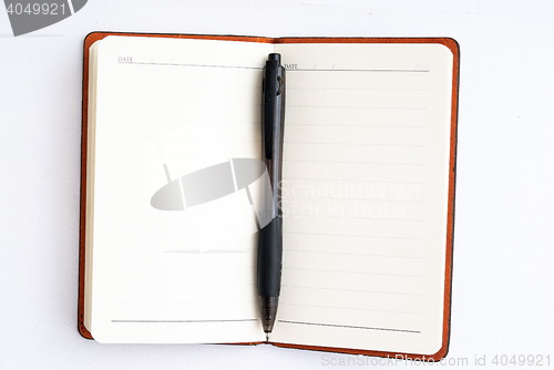 Image of notepad with pen isolated