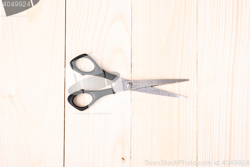 Image of Scissors on wooden background